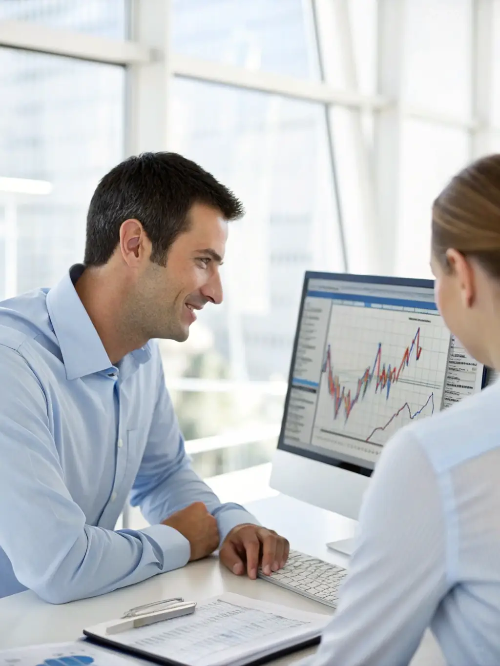 An image of Phillip Suarez discussing investment options with a client, emphasizing personalized financial planning.